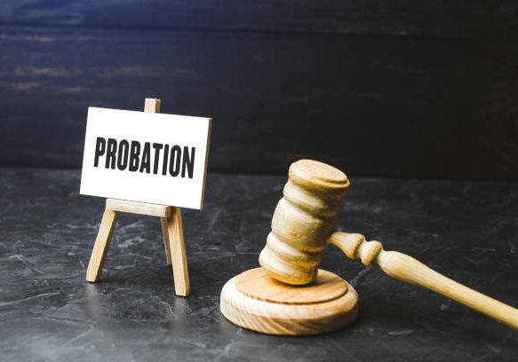 a small easel displays the word "probation" next to a gavel